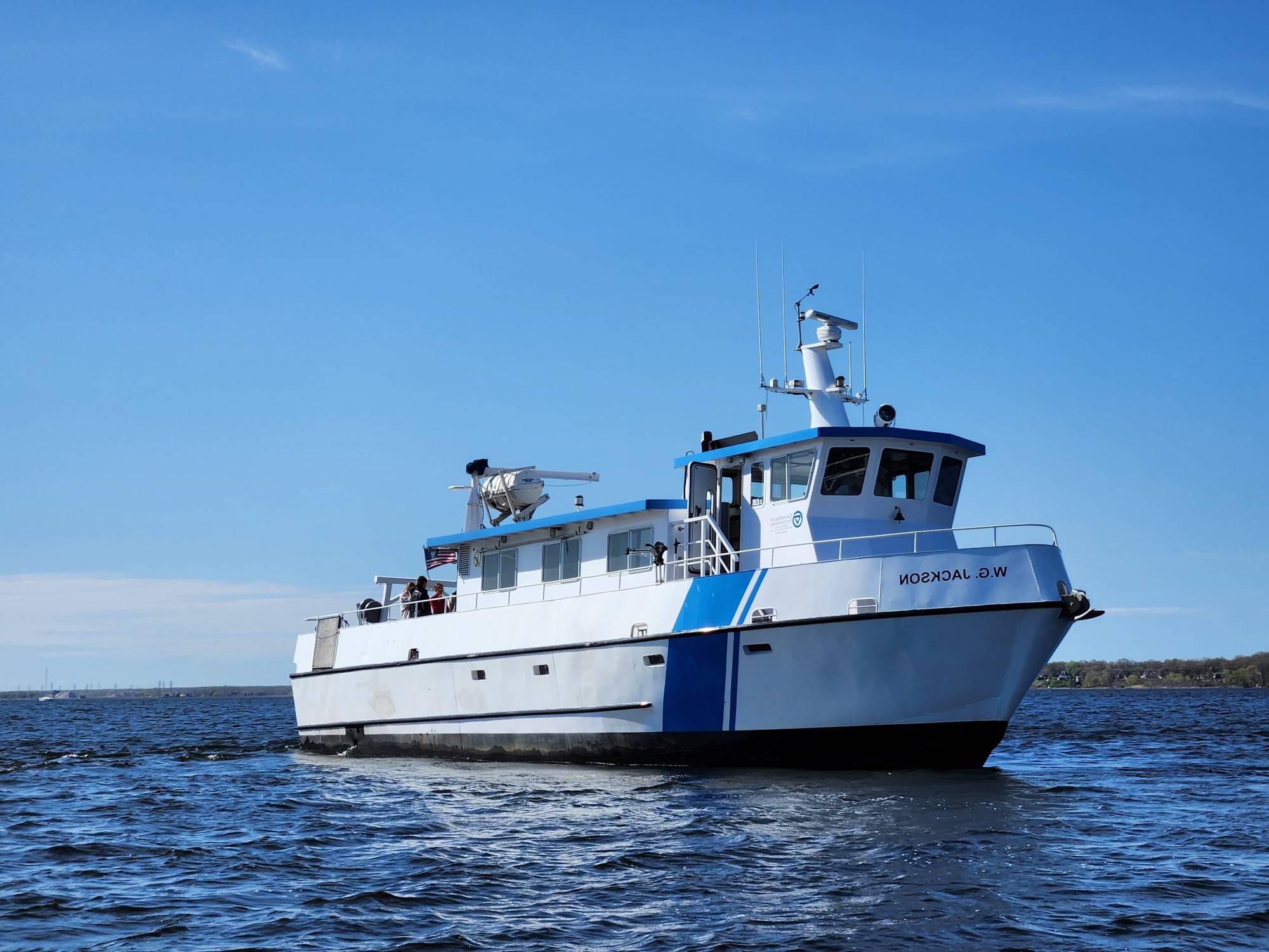 W.G. Jackson Research and Education vessel cruising on lake with blue sky in background